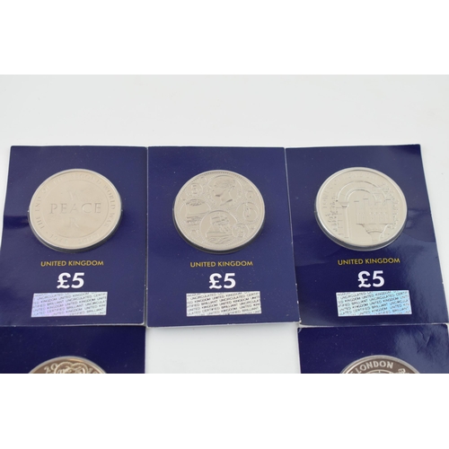 494 - A collection of carded Change Checker £5 coins to include British Red Cross, Vale of Beaufort and ot... 