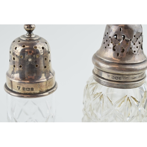 520 - Silver to include a loaded candlestick, 20.5cm tall, gross 268.1g, with two silver topped sugar shak... 