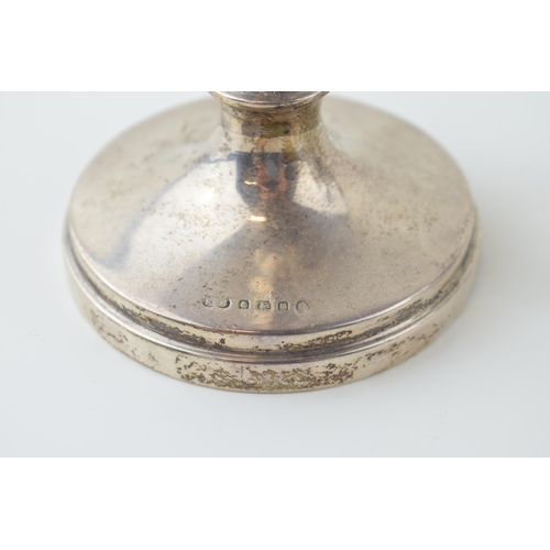 520 - Silver to include a loaded candlestick, 20.5cm tall, gross 268.1g, with two silver topped sugar shak... 