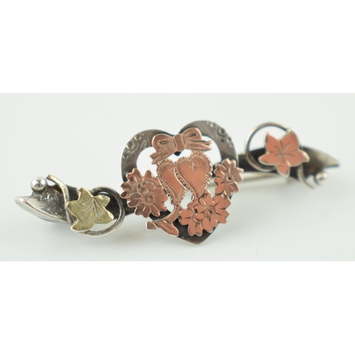 524 - A Victorian silver brooch with double heart design fronted in rose gold and leaf in yellow gold. Wid... 