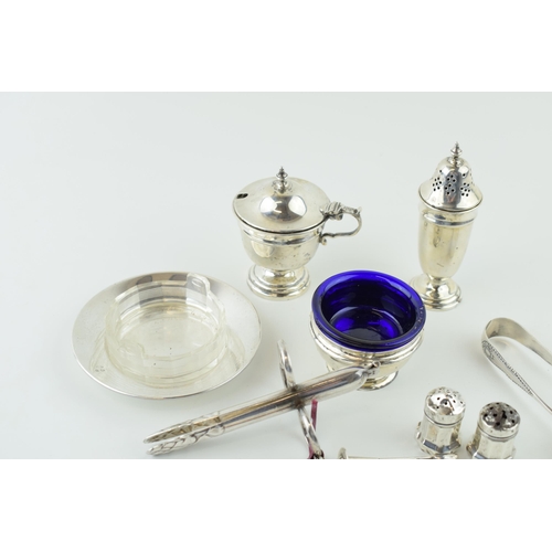 526 - Hallmarked silver to include a pair of tongs, condiments and a dish with glass liner, silver weight ... 