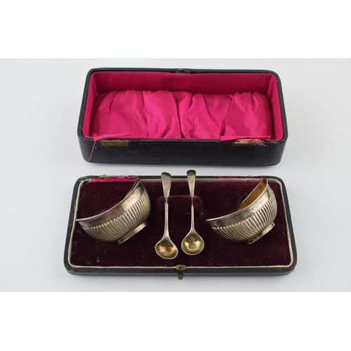 534 - Pair of silver table salts with Chester spoons, 49.2g, in fitted case which is af.