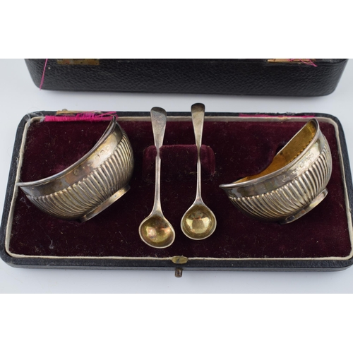 534 - Pair of silver table salts with Chester spoons, 49.2g, in fitted case which is af.