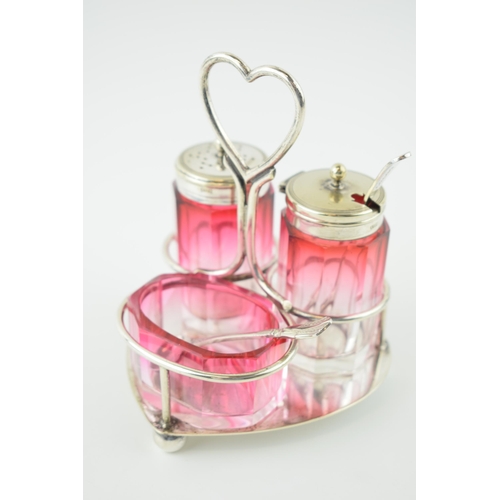 540 - Silver plated cranberry glass cruet set, on plated hold, gradient colours, unmarked but possibly Bac... 