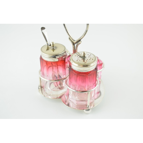 540 - Silver plated cranberry glass cruet set, on plated hold, gradient colours, unmarked but possibly Bac... 