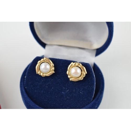 620 - A pair of cased 14ct yellow gold pearl studs (gross weight 1.1 grams) together with a pair of cased ... 