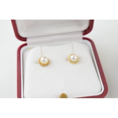 620 - A pair of cased 14ct yellow gold pearl studs (gross weight 1.1 grams) together with a pair of cased ... 