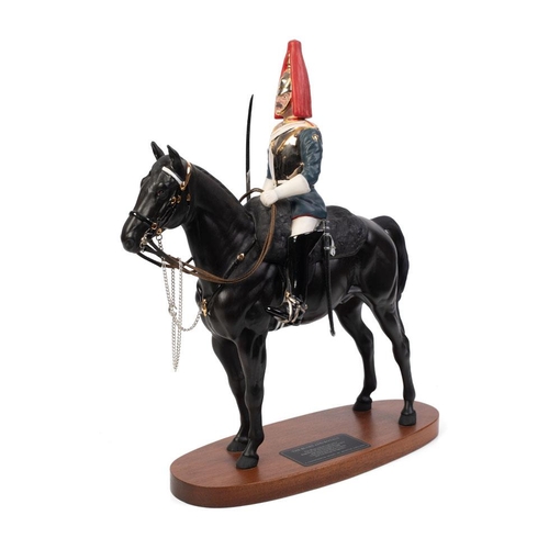 Beswick figure of a soldier on a horse, Blues and Royals, 2582 by Graham Tongue, Connoisseur Horses series, on oval wood plinth, approx. 36cm high.