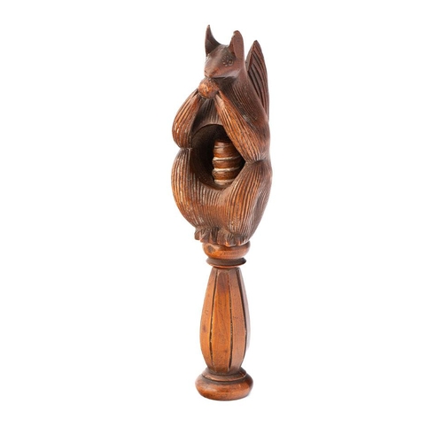 21 - 19th century fruitwood screw-action novelty nut cracker in the form of a squirrel, 17cm tall.