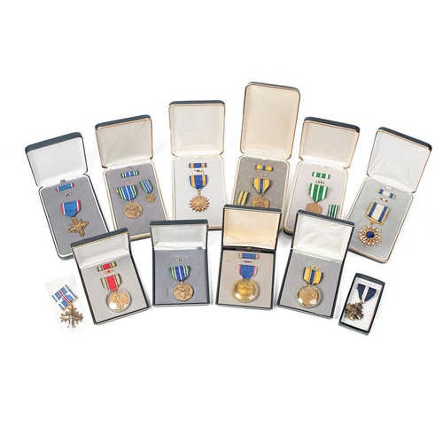 64 - A collection of vintage cased American Military Service Medals to include 'Distinguished Service Cro... 