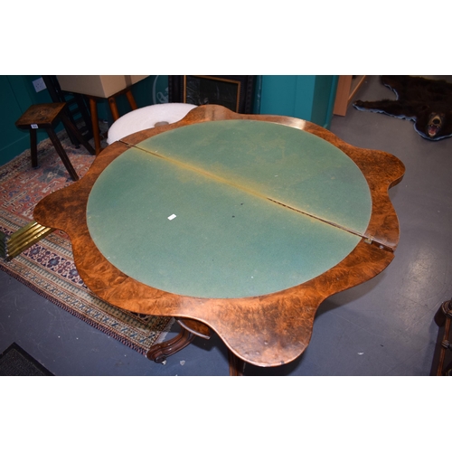 41 - Victorian burr walnut folding card table, ornate base, on four casters, felt top to interior, shaped... 