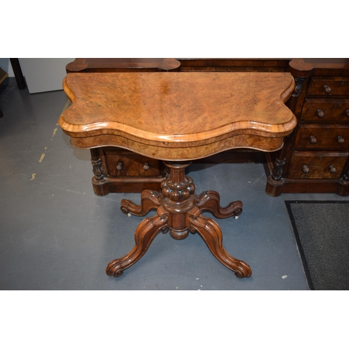 41 - Victorian burr walnut folding card table, ornate base, on four casters, felt top to interior, shaped... 