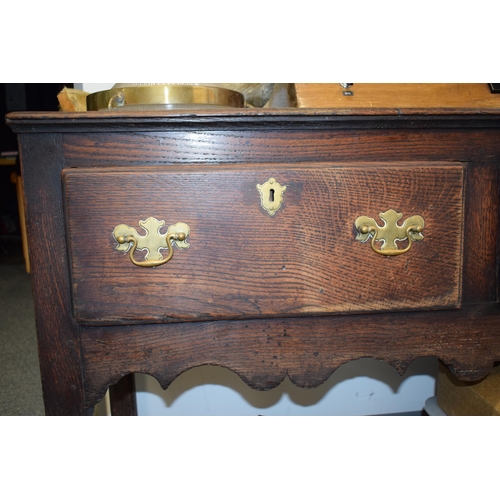 42 - Late 18th / early 19th century oak dresser base, three drawers, turned legs, brass handles and escut... 