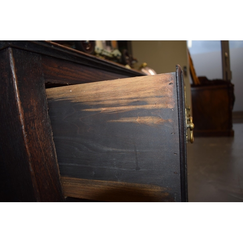 42 - Late 18th / early 19th century oak dresser base, three drawers, turned legs, brass handles and escut... 