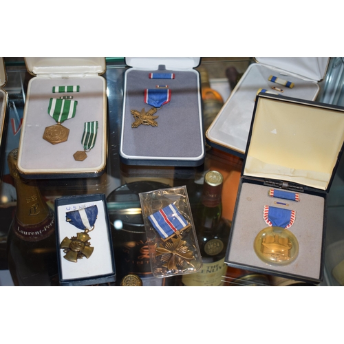 64 - A collection of vintage cased American Military Service Medals to include 'Distinguished Service Cro... 