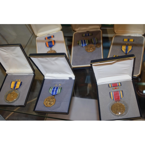 64 - A collection of vintage cased American Military Service Medals to include 'Distinguished Service Cro... 