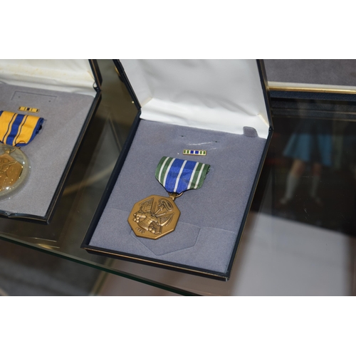 64 - A collection of vintage cased American Military Service Medals to include 'Distinguished Service Cro... 