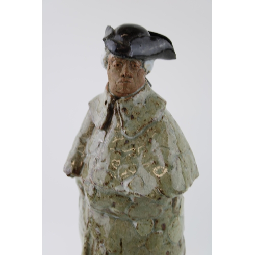 137 - A studio pottery figure of a gentleman in Tricorn hat on marble base. Indistinguishable monogram / s... 