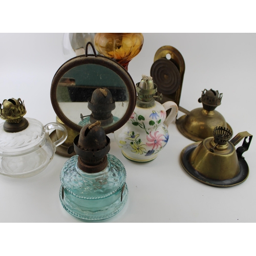 460 - A mixed collection of vintage and antique tin, pottery and brass oil lamps with glass chimneys and p... 