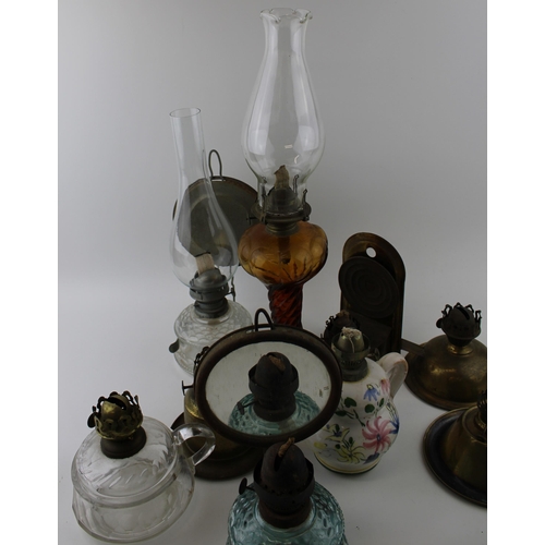 460 - A mixed collection of vintage and antique tin, pottery and brass oil lamps with glass chimneys and p... 