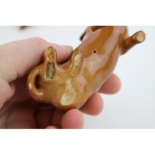 16 - Beswick small Dachshunds to include a standing dachshund and a lying example (2).