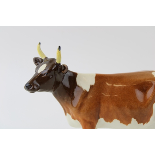 36 - Beswick Ayrshire cow (restored horns) with an Ayrshire cow (chipped ear) (2).