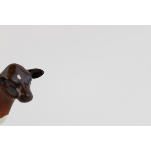 36 - Beswick Ayrshire cow (restored horns) with an Ayrshire cow (chipped ear) (2).