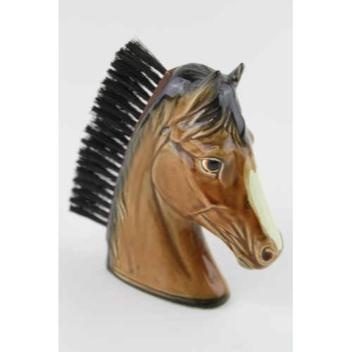 56 - A pottery brush in the form of a horse's head, 11.5cm tall.