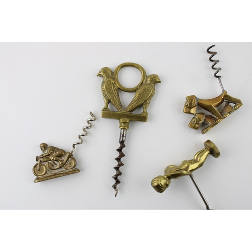 13 - Four novelty brass corkscrews to include a motorbiker, a putti, two dogs and two birds (4).