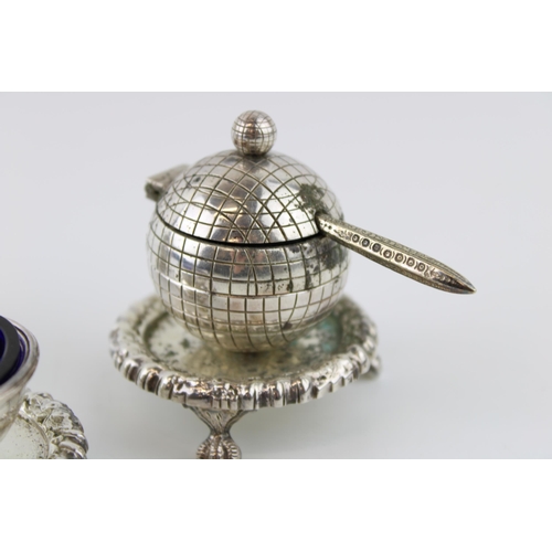 14 - Unusual silver plated globular cruet set, two with blue glass liners.