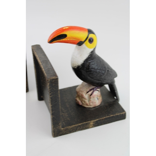 37 - A pair of cast metal bookends with Toucans sitting on rocks. Height 16cm.