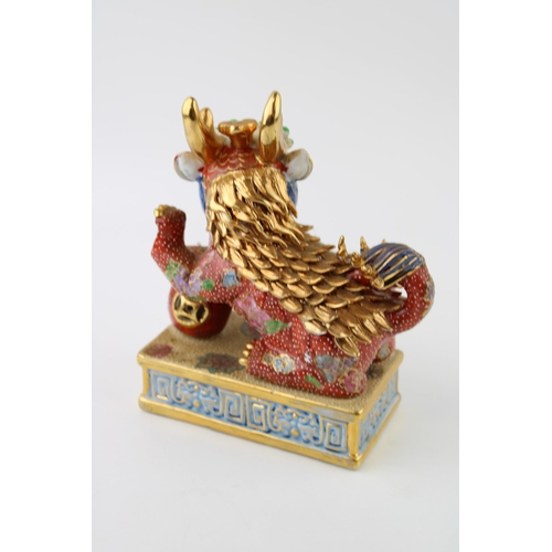 40 - Contempory Chinese Fu Dog ceramic figure on wooden stand. Height 30cm.