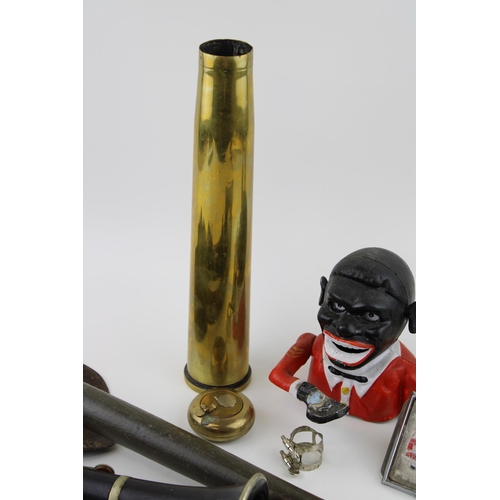 68 - A mixed collection of items to include replica Jolly Boy money box, military spade, shell casing and... 