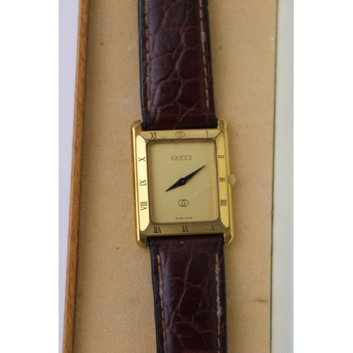 101 - A vintage gentleman's Gucci gold plated watch on leather strap in original box. Case diameter 24mm.