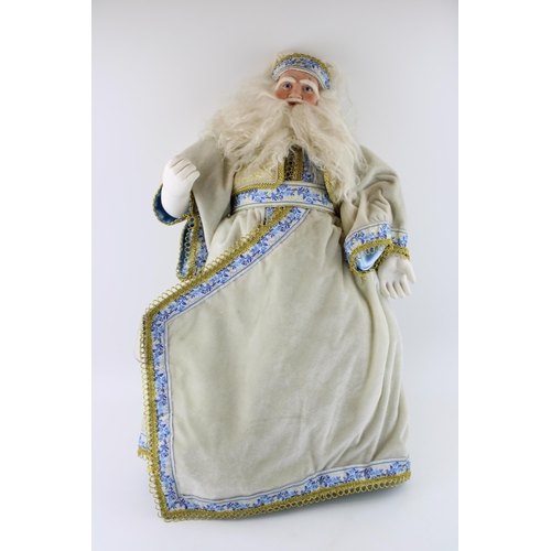 122 - A Thomas Kinkade Santa Claus in traditional white dress. Height 60cm.