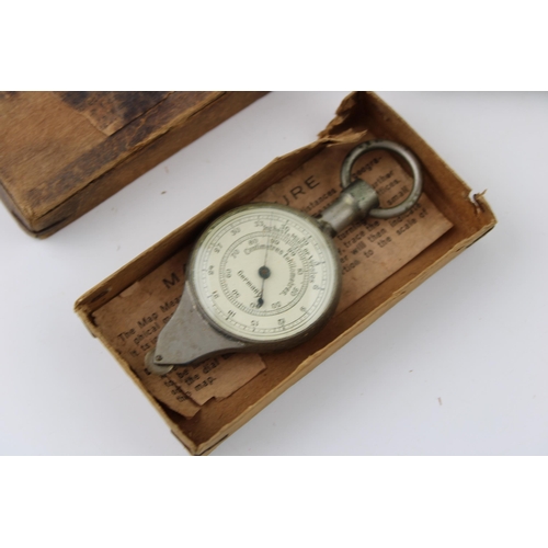 123 - A boxed Map Measure, appears to be working, with an Eastern silver plated and brass cigarette case (... 