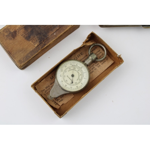 123 - A boxed Map Measure, appears to be working, with an Eastern silver plated and brass cigarette case (... 