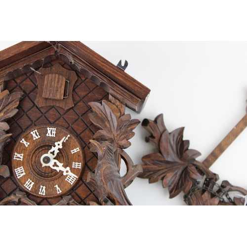 99 - A vintage Black Forrest style cuckoo clock. Height 34cm.