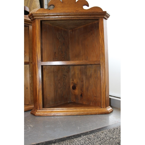 157 - A pair of corner cupboards. Height 55cm, width 38cm.