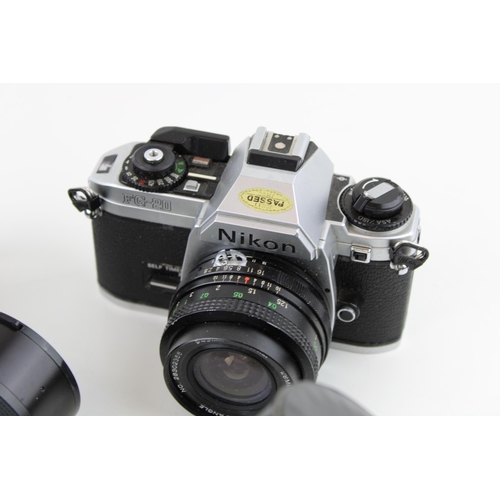 172 - A collection of vintage cameras and lenses to include a Pentax K1000 SLR, a Nikon FG - 20 together w... 