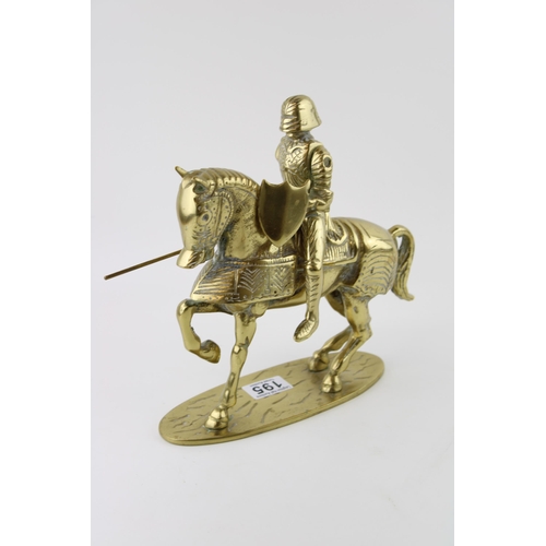 195 - A brass knight on horse back with articulated lance. Height 35cm. Weight 4.5kg