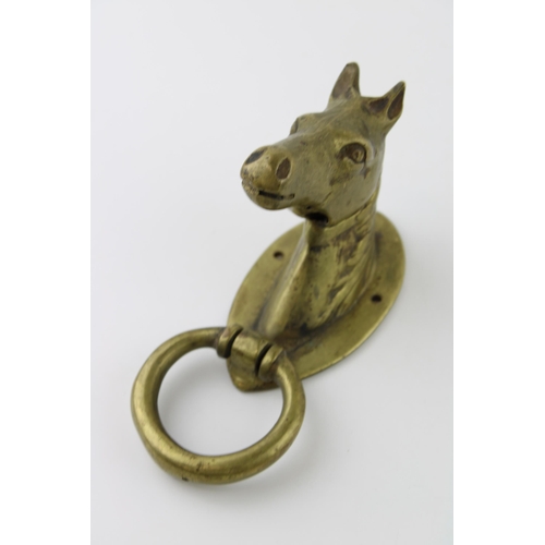 196 - A brass door knocker in the form of a horses head. Weight 1kg