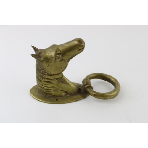 196 - A brass door knocker in the form of a horses head. Weight 1kg