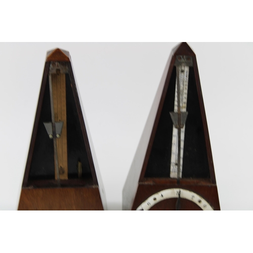 208 - Two wooden cased metronomes, 23cm tall (2).