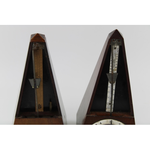 208 - Two wooden cased metronomes, 23cm tall (2).