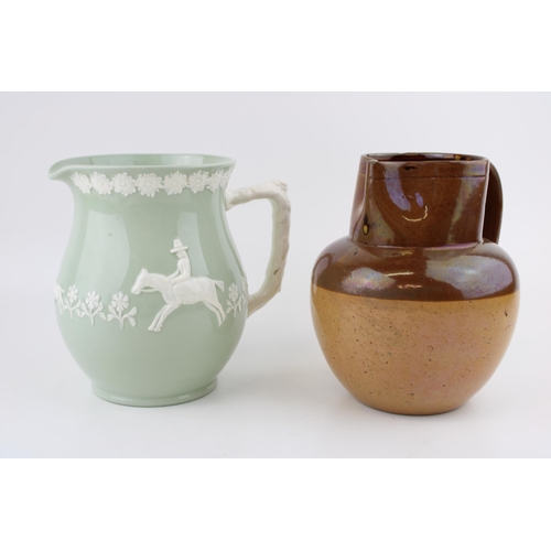 102 - A Copeland Spode K916 pale green glazed jug with applied relief decoration of man on horseback with ... 