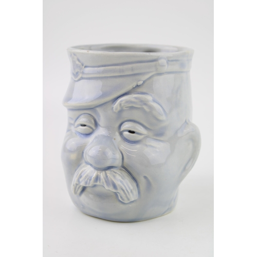 112 - World War One era pottery character jug of Bruce Bainsfather, light blue glaze, 11cm tall, unmarked.