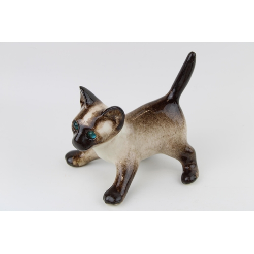 116 - A trio of Winstanley pottery cats to include a Siamese cat, a ginger kitten and one other, 15cm tall... 