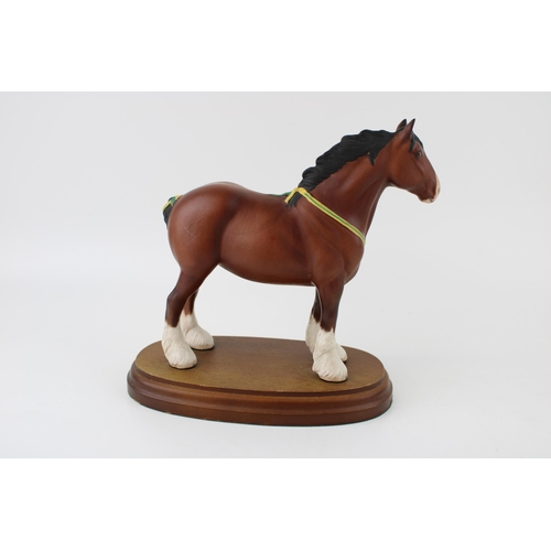 158 - Royal Doulton bay shire horse with yellow and green ribbon, on wooden base, 19cm wide.