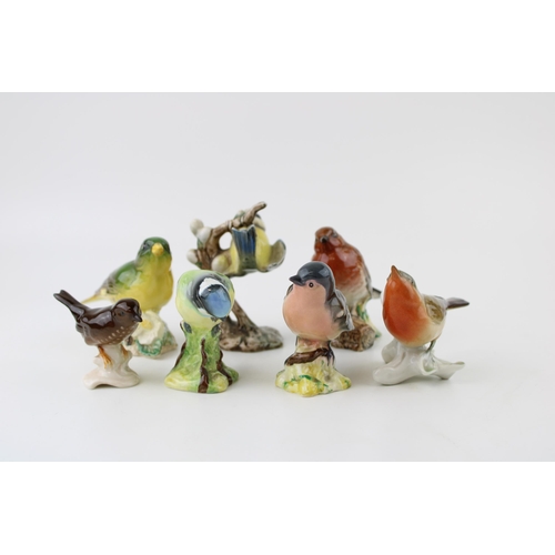 159 - A collection of Beswick, W Goebel and similar manufactures birds. To include Blue Tit, Robin, Greenf... 